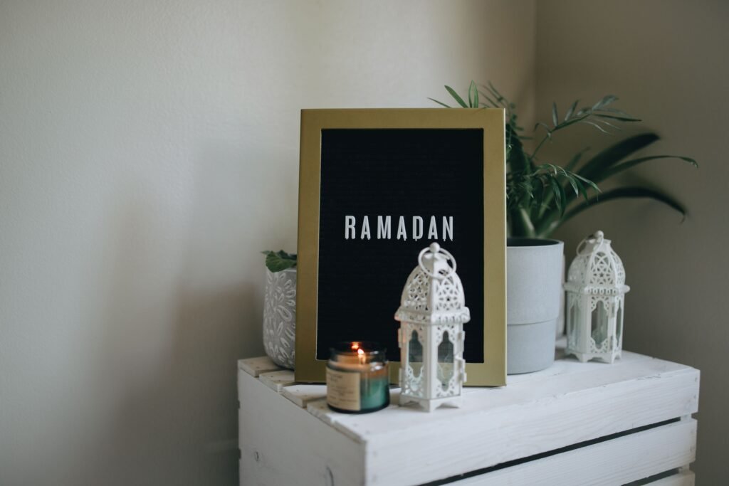 Beautiful Ramadan-themed decor featuring lanterns, potted plants, and a framed sign on a side table.